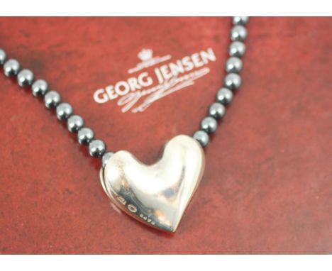 A Georg Jensen silver pendant, the heart shaped pendant stamped 'Georg Jensen 925S Denmark 247B', upon a string of hematite b