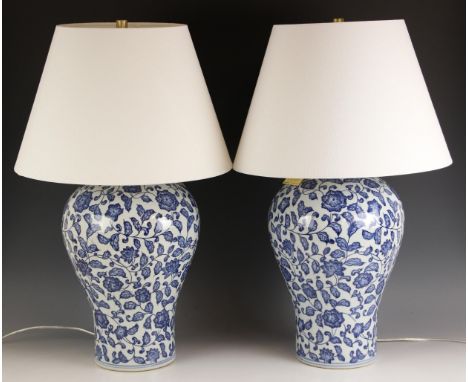 A pair of Ralph Lauren Chinese influence blue and white vase table lamps, of baluster form with conforming white shades, 70cm