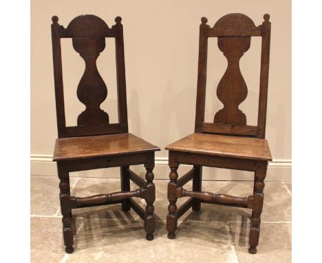 A pair of 18th century oak side chairs, the vase shaped splats above a board seat, upon block and bobbin turned supports unit