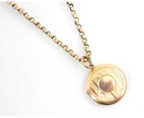 An early 20th century 9ct yellow gold locket pendant, the engine turned decorated circular pendant opening to reveal two aper
