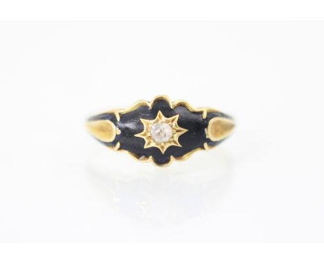 A 19th century diamond set ring, the old cut diamond set within black enamel set head, leading to grooved shoulders and plain