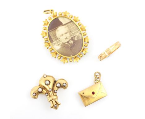 A selection of yellow metal and gold coloured jewellery, including a yellow metal ring with engraved and grooved design, ring