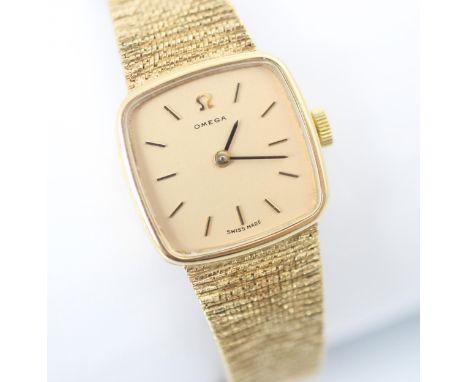 A yellow gold Omega ladies wrist watch, the square shaped gold coloured dial with baton markers, set to plain polished case, 