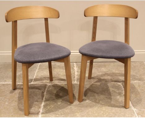 A pair of contemporary light oak and upholstered dining chairs, made in Italy for Heal's, early 21st century, each with a cur