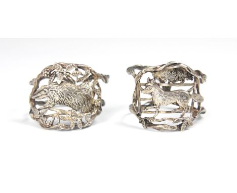 A set of two silver coloured napkin rings, possibly Dutch, the openwork circular rings with stylised rope twist exterior, one