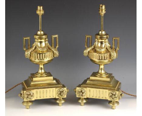 A pair of Victorian lacquered brass lamp bases, late 19th century, the invert break front base raised upon stepped compressed