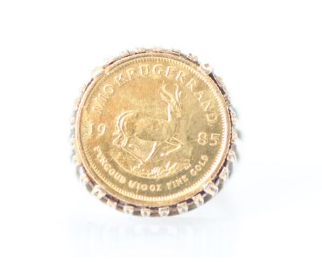 A 1/10 krugerrand coin set ring, the coin dated 1985 within a openwork 9ct mount and plain polished shank, ring size O, 6gms 