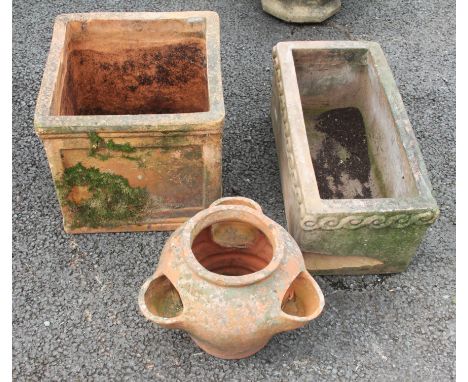 A rectangular terracotta trough planter 57cm long, a cubic terracotta planter, 39cm Sq, along with a terracotta strawberry pl