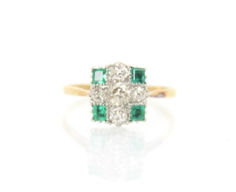 A 20th century Art Deco style diamond and emerald ring, the central old cut diamond with smaller old cut diamonds to each sid