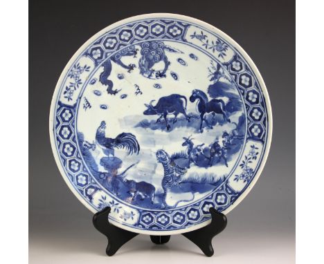 A Chinese porcelain blue and white charger, 19th century, of circular form and decorated with a cockerel, tiger, buffalo, dee