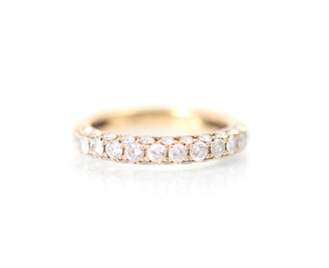 A rose gold diamond half eternity, the row of twelve round cut diamonds with eleven smaller round cut diamonds to each side o