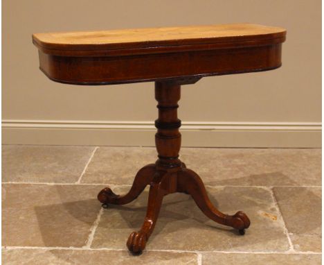 A mid 19th century pollard oak pedestal games table, the rectangular hinged top with rounded front corners upon a ring turned