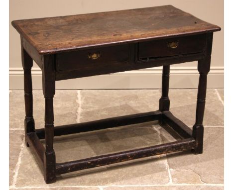 A late 17th/early 18th century oak side table, the rectangular top over two frieze drawers, upon ring turned tapering and blo