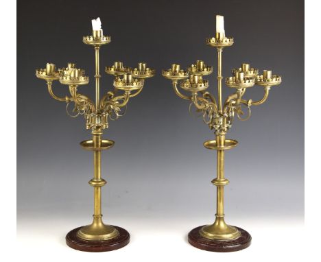 A pair of Ecclesiastical brass six-branch candelabrum with central sconce, late 19th century, each with floral and scroll dec