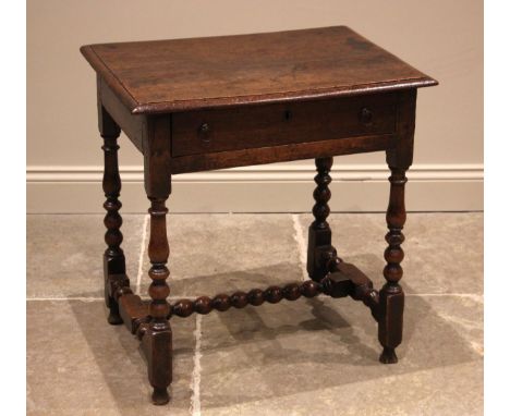 An 18th century oak side table, the rectangular moulded top above a single pine lined drawer, applied with ring handles, upon