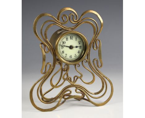 An Art Nouveau brass easel timepiece, early 20th century, the 5cm enamelled drum dial applied with Arabic numerals with integ