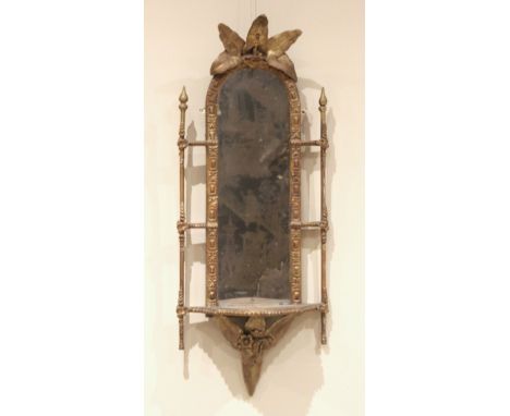 A Victorian giltwood and gesso mirrored wall shelf, 19th century, the moulded arched frame with foliate surmount, the serpent