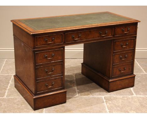 A burr elm veneered twin pedestal desk, late 20th century, the rectangular moulded top inset with a gilt tooled skiver, over 