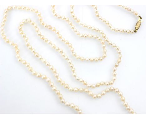 A string of untested pearls, the two hundred and fourteen graduated pearls of non-uniform form with a gold coloured tongue an