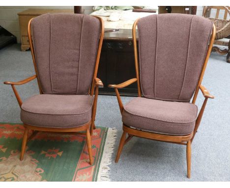 A Pair of Ercol Elm Armchairs, course woolen cushions, stick-backs, shaped arms, turned legs and stretchers (2) 