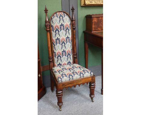 A 19th Century Rosewood Prie Dieu, in the Gothic Revival taste, twin architectural turned and carved finials, tapestry uphols