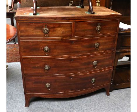 A George III Mahogany Bow-Fronted Four Height Chest of Drawers, lion mask hoop handles, outswept bracket supports, 107cm by 5