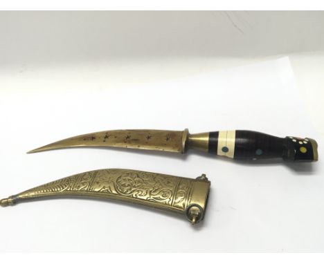 A North African knife with decorated handle in a brass scabbard.