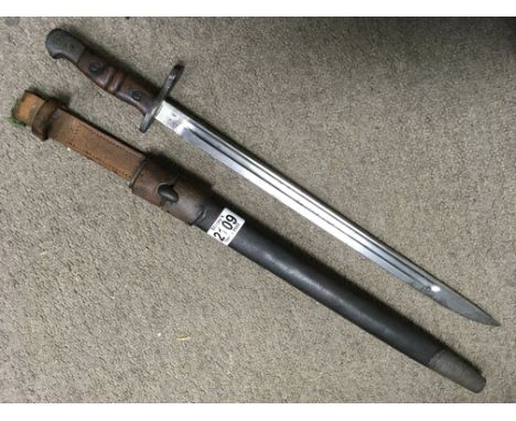 A WW1 bayonet with Leather scabbard, impressed marks to the steel blade