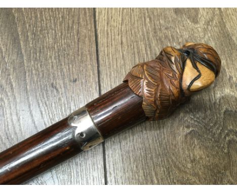 A novelty walking stick with carved parrot handle