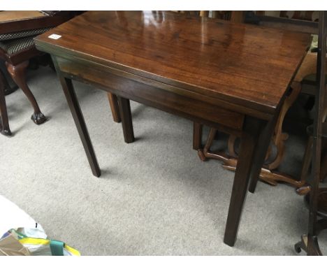 A George III mahogany card table the twin flap top on square chamfered legs.