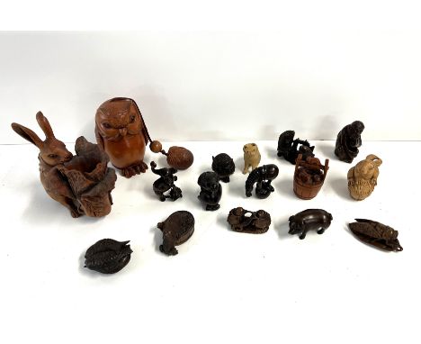 A collection of Chinese carved fruitwood netsuke together with a carved Owl Inro and a Carved fruitwood Rabbit.