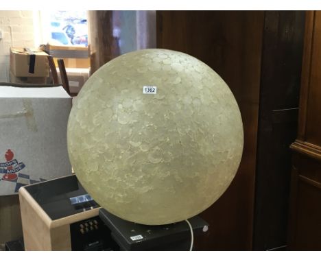 A large modern design floor standing light sphere.