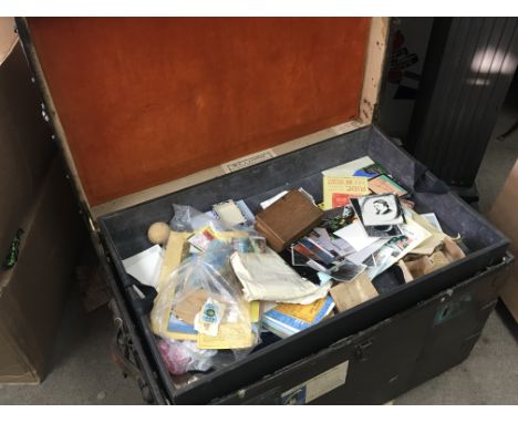 An Antique traveling trunk wood bound metal and canvas with four detachable lined trays. Sold with contents.