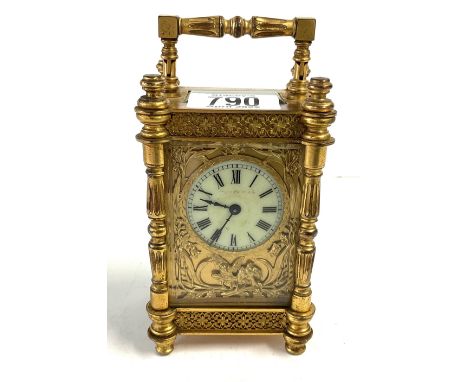 An ornately decorated 4 glass gilt brass carriage clock, 15.5cm. (Issue with foot).