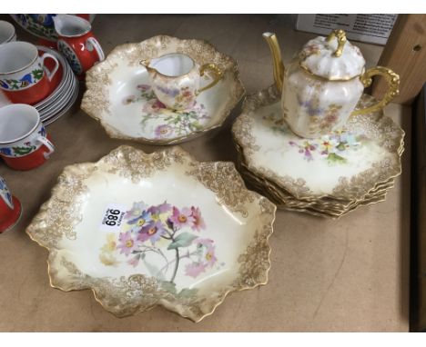 A part Doulton dessert service decorated with flowers and foliage and a French tea pot and milk jug