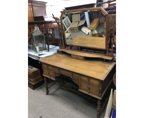 A Quality Oak dressing table with a Bevelled edge mirror. with turned double supports above drawers.