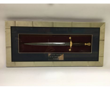 A framed Wilkinson Sword trophy knife for The Superstars 1974 presented to Joe Bugner.