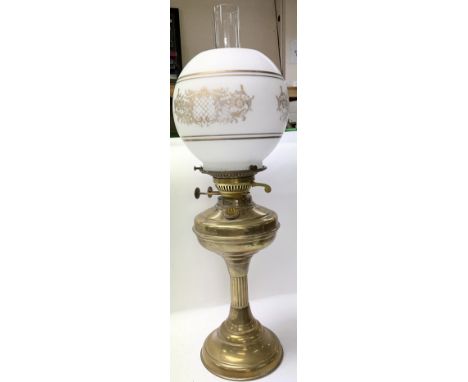 A late Victorian brass oil lamp and shade.
