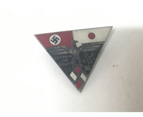 A 1939 TThird Reich German Hitler Youth Badge of rectangular shape decorated with enamel with German and Japanese symbols.