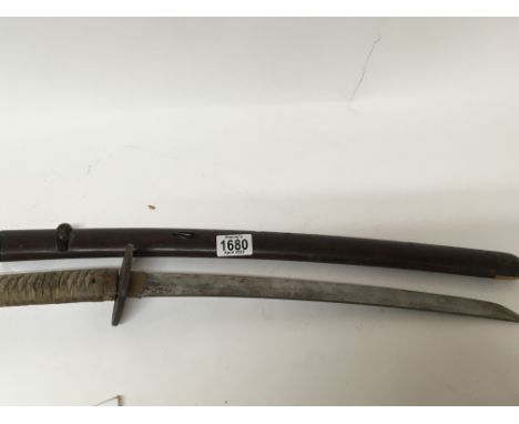 A Japanese 19th century or possibly earlier 18th century Katana sword with shagree grip lacquered scabbard blade length 49cm