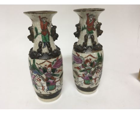 A Pair of Chinese crackleware vases enamel decorated and with raised dragons. Height 20cm No obvious damage or restoration.