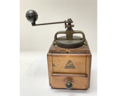 A vintage wooden and brass coffee grinder branded Alexander.