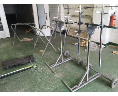 A collection of car panel stands and adjustable spray racks and an under car mechanic trolley and a LED under car inspection 