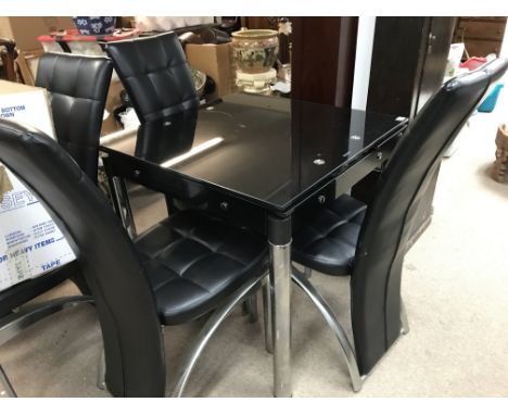 A chrome and leather modern dining table and four chairs. The table measurements are approximately 80cm x 80cm x 75cm - NO RE