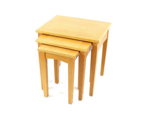 A nest of three light oak occasional tables, 55cm wide in extremes