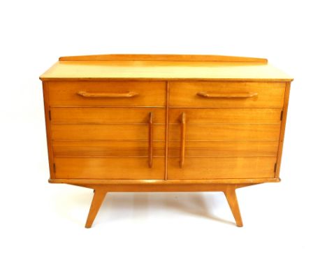 A G-plan light wood sideboard, fitted two drawers and cupboards below raised on square section supports, 124cm wide