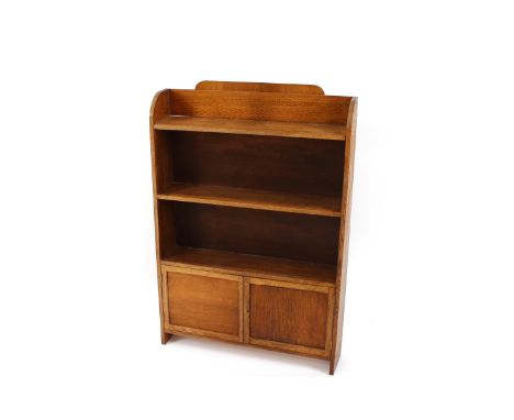 A 1930's light oak bookcase, with cupboard base, 68cm wide x 97cm high