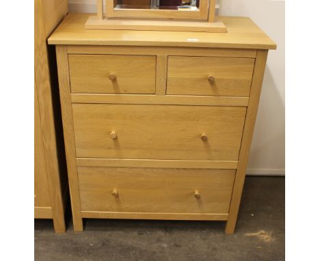 A modern light wood chest, of two short and two long drawers, raised on square section supports, 82cm wide