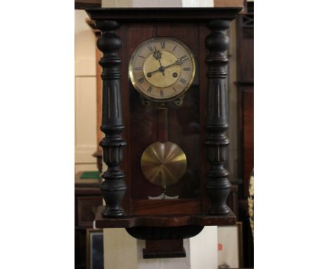 An early 20th century wall clock in glazed case with brass pendulum, 57cm high