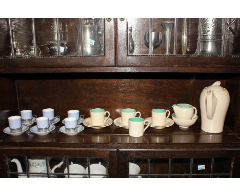 A Susie Cooper kestrel shape coffee pot, cream jug, sugar bowl, four cups and six saucers, in cream glaze with turquoise inte